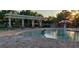 Community pool with mushroom fountain and shaded seating area at 11464 52Nd E Ct, Parrish, FL 34219