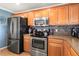 Modern kitchen with stainless steel appliances and wood cabinets at 7407 64Th E St, Palmetto, FL 34221