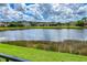 Scenic view of a lake with houses and lush greenery in the background at 7407 64Th E St, Palmetto, FL 34221