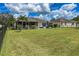 Large backyard with spacious lawn, palm trees and a screened patio at 7407 64Th E St, Palmetto, FL 34221