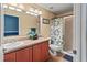 Bathroom with double sinks, a shower, and a floral shower curtain at 7407 64Th E St, Palmetto, FL 34221
