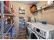 Convenient laundry room with washer, dryer, and ample storage shelves at 7407 64Th E St, Palmetto, FL 34221