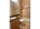 Bathroom with tub, toilet, and vanity with dark countertop at 10228 Silverado Cir, Lakewood Ranch, FL 34202