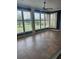 Bright sunroom with tile flooring, multiple windows, and plantation shutters at 10228 Silverado Cir, Lakewood Ranch, FL 34202