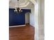 Formal dining room with hardwood floors, decorative chandelier, and accent wall at 10228 Silverado Cir, Lakewood Ranch, FL 34202