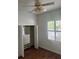 Bedroom with hardwood floors, ceiling fan, and window with shutters at 10228 Silverado Cir, Lakewood Ranch, FL 34202