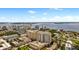 Aerial view showing condo building, pool, and surrounding cityscape at 800 N Tamiami Trl # 402, Sarasota, FL 34236