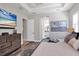 Bright bedroom with ensuite bathroom access and large TV at 13212 Deep Blue Pl, Lakewood Ranch, FL 34211