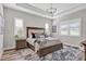 Spacious primary bedroom with plush bed and large windows at 13212 Deep Blue Pl, Lakewood Ranch, FL 34211