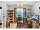 Home office with built-in shelving, hardwood floors, and ample workspace at 13212 Deep Blue Pl, Lakewood Ranch, FL 34211