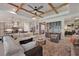 Spacious living area with sectional sofa, kitchen views, and wood beams at 13212 Deep Blue Pl, Lakewood Ranch, FL 34211