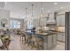 Modern kitchen with large island, stainless steel appliances, and breakfast bar at 13212 Deep Blue Pl, Lakewood Ranch, FL 34211