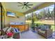 Screened patio with hot tub, comfortable seating, and outdoor TV at 13212 Deep Blue Pl, Lakewood Ranch, FL 34211