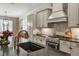 Sleek kitchen with gas range, custom cabinetry, and large island at 13212 Deep Blue Pl, Lakewood Ranch, FL 34211