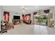 Living room with comfortable seating, fireplace, and sliding glass doors to backyard at 6122 44Th E Ct, Bradenton, FL 34203