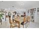 Dining room with a large wooden table and chairs, view into living room and kitchen at 6122 44Th E Ct, Bradenton, FL 34203