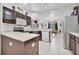 Open kitchen with L-shaped island, dark wood cabinets, and stainless steel appliances at 6122 44Th E Ct, Bradenton, FL 34203