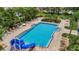 Community pool with surrounding lounge chairs and palm trees at 6122 44Th E Ct, Bradenton, FL 34203