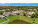 Aerial view of homes and community landscape with pond at 6122 44Th E Ct, Bradenton, FL 34203