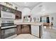 Modern kitchen with stainless steel appliances, dark wood cabinets, and a convenient island at 6122 44Th E Ct, Bradenton, FL 34203