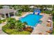 Community pool with lounge chairs, tiki hut, and waterslide at 6122 44Th E Ct, Bradenton, FL 34203