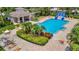 Community pool with lounge chairs, tiki hut, and waterslide at 6122 44Th E Ct, Bradenton, FL 34203
