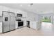 Open kitchen concept with stainless steel appliances, white cabinets and countertops, and a view of the patio at 16647 San Nicola Pl, Lakewood Ranch, FL 34211