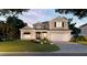 Two-story home with a white exterior, double front doors, and a two-car garage at 1876 Magnolia St, Sarasota, FL 34239