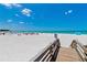 Beach access with boardwalk, loungers and umbrellas at 225 Sands Point Rd # 6103, Longboat Key, FL 34228