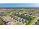 An aerial view of a community, showcasing numerous homes, serene ponds, and lush green spaces at 9478 Tequila Sunrise Dr, Sarasota, FL 34241
