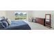A bright main bedroom features carpet, large windows, neutral paint, and a slider with backyard views at 9478 Tequila Sunrise Dr, Sarasota, FL 34241