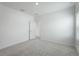 Well-lit bedroom with grey carpet and an additional door at 9478 Tequila Sunrise Dr, Sarasota, FL 34241