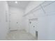 Laundry room with overhead shelving and tile floor at 9478 Tequila Sunrise Dr, Sarasota, FL 34241