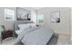 Grey bedroom with queen bed, nightstand and two windows at 9478 Tequila Sunrise Dr, Sarasota, FL 34241