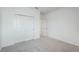 Simple bedroom with grey carpet and double door closet at 9478 Tequila Sunrise Dr, Sarasota, FL 34241