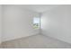 Spacious bedroom with grey carpet and a window with blinds at 9478 Tequila Sunrise Dr, Sarasota, FL 34241