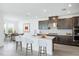 Modern kitchen with a large island, dark wood cabinets, and quartz countertops at 9478 Tequila Sunrise Dr, Sarasota, FL 34241