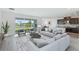 Open living room featuring a spacious layout, large windows, and access to the backyard at 9478 Tequila Sunrise Dr, Sarasota, FL 34241