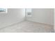 Simple bedroom with grey carpet and window with blinds at 9478 Tequila Sunrise Dr, Sarasota, FL 34241
