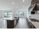 Open concept kitchen with an island, stainless steel appliances, and ample counter space at 9478 Tequila Sunrise Dr, Sarasota, FL 34241