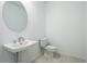 Clean bathroom with pedestal sink and toilet at 9478 Tequila Sunrise Dr, Sarasota, FL 34241