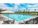 Refreshing lap pool with plenty of lounge chairs and tables at 9478 Tequila Sunrise Dr, Sarasota, FL 34241