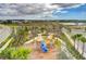 Community playground with play structures near a lake at 9478 Tequila Sunrise Dr, Sarasota, FL 34241