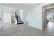 Open floor plan foyer with light grey flooring and stairs at 9478 Tequila Sunrise Dr, Sarasota, FL 34241