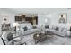 Living room with neutral color palette, contemporary furniture, and an open concept design at 9478 Tequila Sunrise Dr, Sarasota, FL 34241