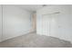 Bright bedroom with grey carpet, double door closet and an additional door at 9478 Tequila Sunrise Dr, Sarasota, FL 34241