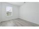 Simple bedroom with grey flooring and a window at 9478 Tequila Sunrise Dr, Sarasota, FL 34241