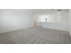 Open loft area with grey carpet and multiple windows at 9478 Tequila Sunrise Dr, Sarasota, FL 34241