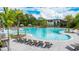 Resort-style pool with lounge chairs and shaded seating areas at 9478 Tequila Sunrise Dr, Sarasota, FL 34241