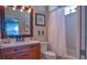 Guest bathroom with tub shower combo and wood vanity at 7823 33Rd E St # 20, Sarasota, FL 34243